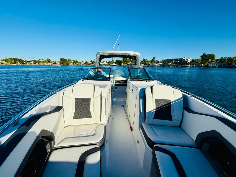 Slide: The Image of 2020 Monterey 328 SS boat on calm water, featuring luxurious seating and sleek design. - 43