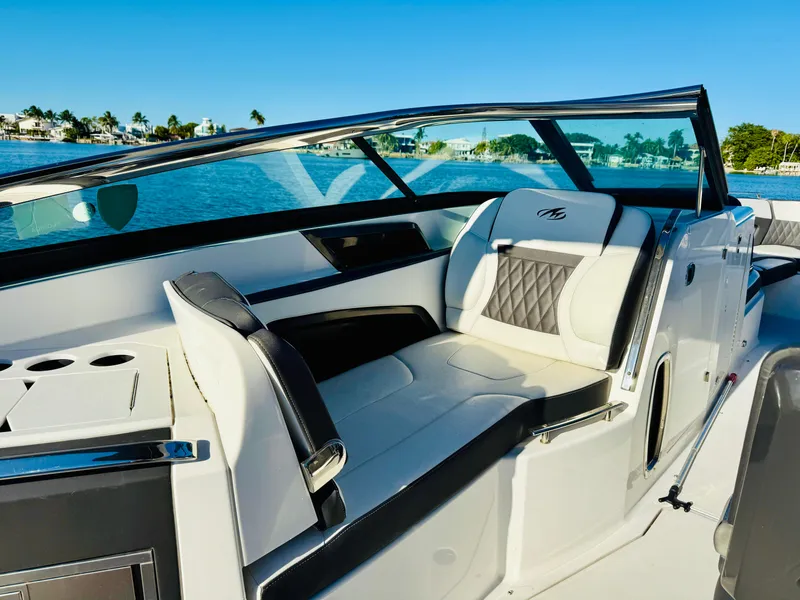 Slide: The Image of 2020 Monterey 328 SS boat interior with luxurious seating and scenic water view. - 46