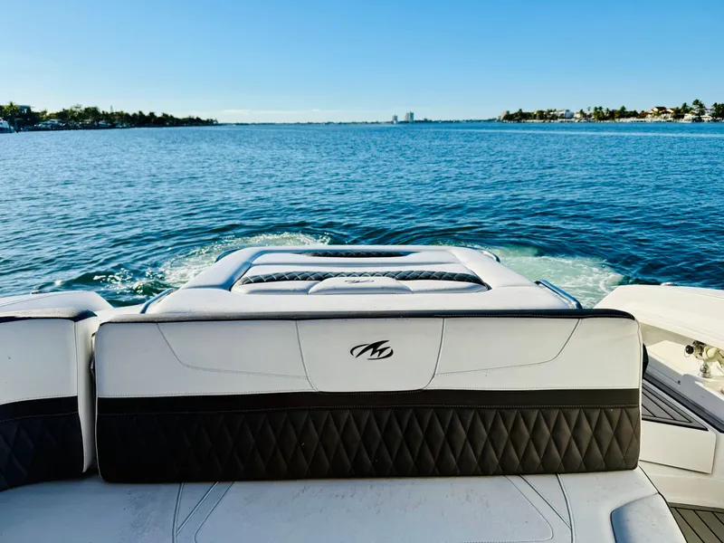 Slide: The Image of 2020 Monterey 328 SS boat on serene blue water, rear seating view. - 47