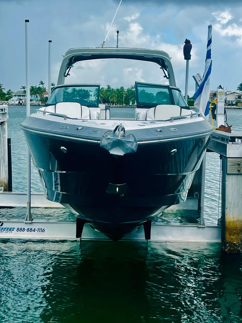 Slide: The Image of 2020 Monterey 328 SS boat docked at marina, cloudy sky background. - 6