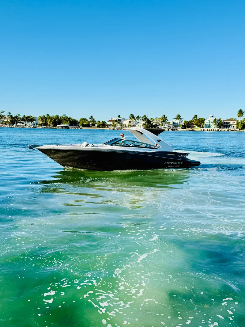 Slide: The Image of 2020 Monterey 328 SS boat cruising on clear blue water under a sunny sky. - 9