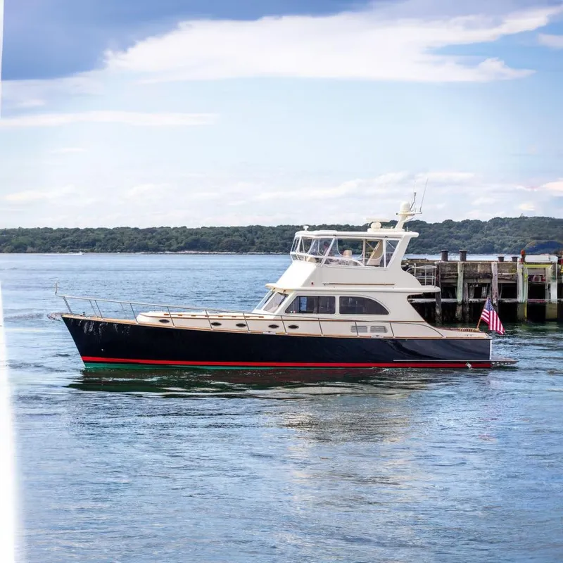 The Image of 2007 Vicem 54 Classic Flybridge yacht docked by the pier, with scenic water backdrop. - 0