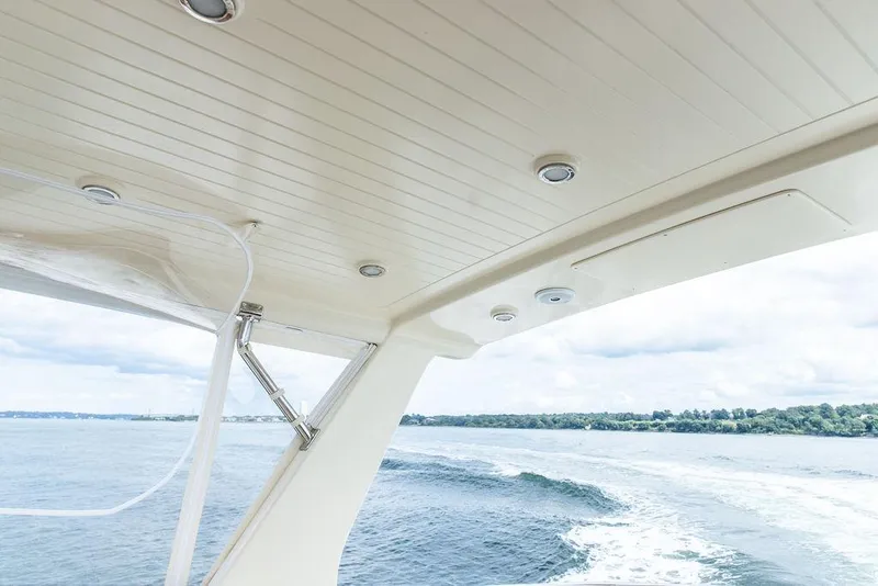 Slide: The Image of 2007 Vicem 54 Classic Flybridge yacht deck with seating and American flag. - 25