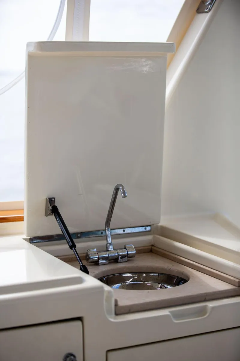 Slide: The Image of Vicem 54 Classic Flybridge 2007 yacht deck with striped seating and American flag. - 26