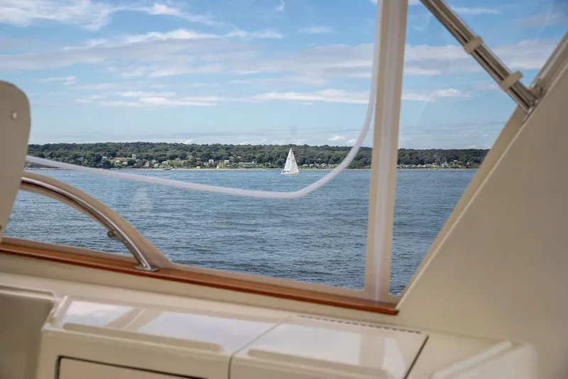 Slide: The Image of Vicem 54 Classic Flybridge 2007 yacht with striped seating and ocean waves. - 27