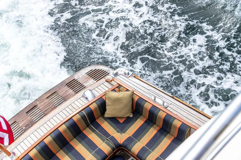 Slide: The Image of 2007 Vicem 54 Classic Flybridge yacht docked near a pier, featuring elegant design and American flag. - 9