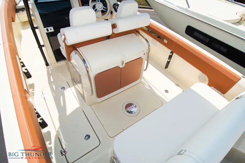 Slide: The Image of 2024 Capoforte FX270 boat interior with white and tan seating, modern design. - 11
