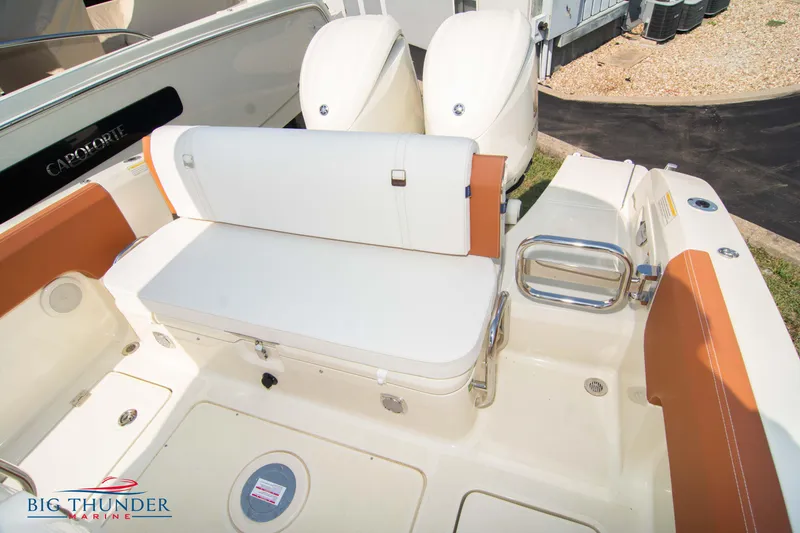 Slide: The Image of 2024 Capoforte FX270 boat interior with white seating and dual engines. - 12