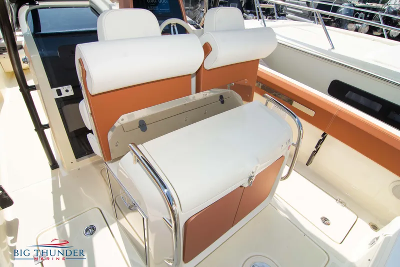 Slide: The Image of 2024 Capoforte FX270 boat interior with white and tan seating, sleek design, and modern features. - 15