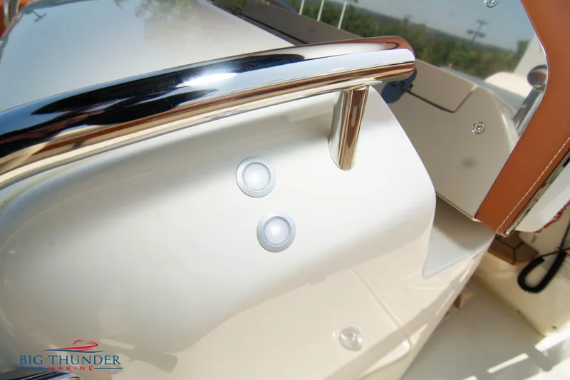 Slide: The Image of 2024 Capoforte FX270 boat detail with chrome railing and control buttons. - 16