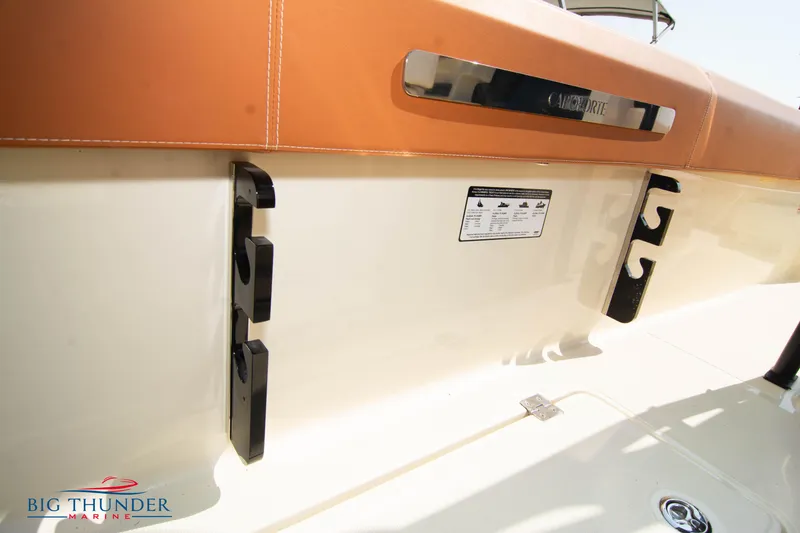 Slide: The Image of 2024 Capoforte FX270 boat interior with tan upholstery and storage hooks. - 19