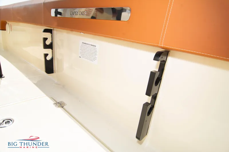 Slide: The Image of 2024 Capoforte FX270 boat interior detail with storage hooks and branding. - 20