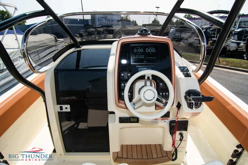 Slide: The Image of 2024 Capoforte FX270 boat dashboard with steering wheel and control panel. - 21