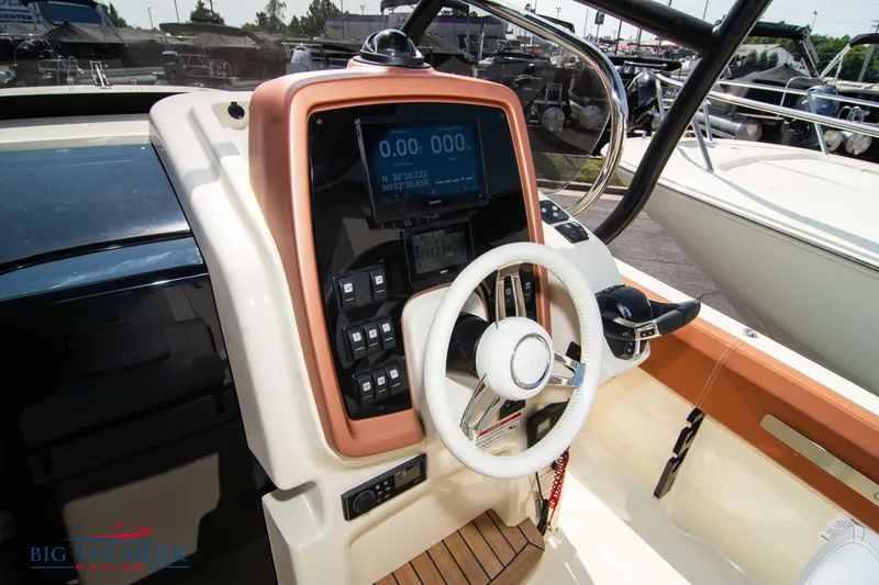 Slide: The Image of 2024 Capoforte FX270 boat dashboard with steering wheel and control panel. - 24