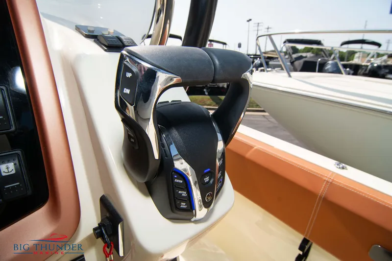 Slide: The Image of 2024 Capoforte FX270 boat control panel with steering wheel and buttons. - 32
