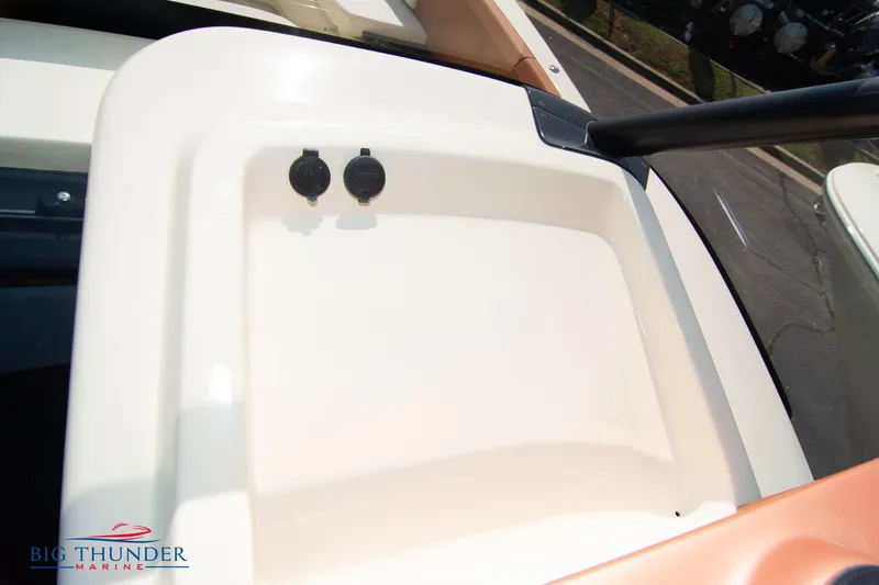 Slide: The Image of 2024 Capoforte FX270 boat deck detail with storage compartment and dual outlets. - 34