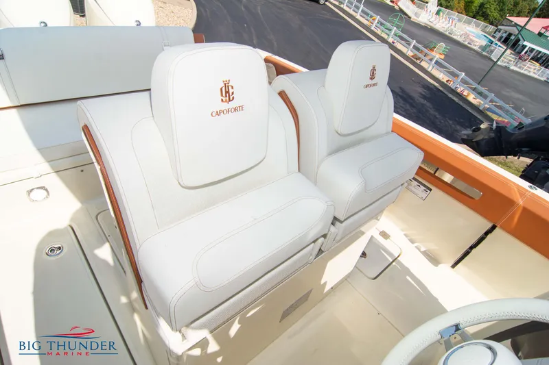 Slide: The Image of 2024 Capoforte FX270 boat seats with white upholstery and logo detailing. - 35