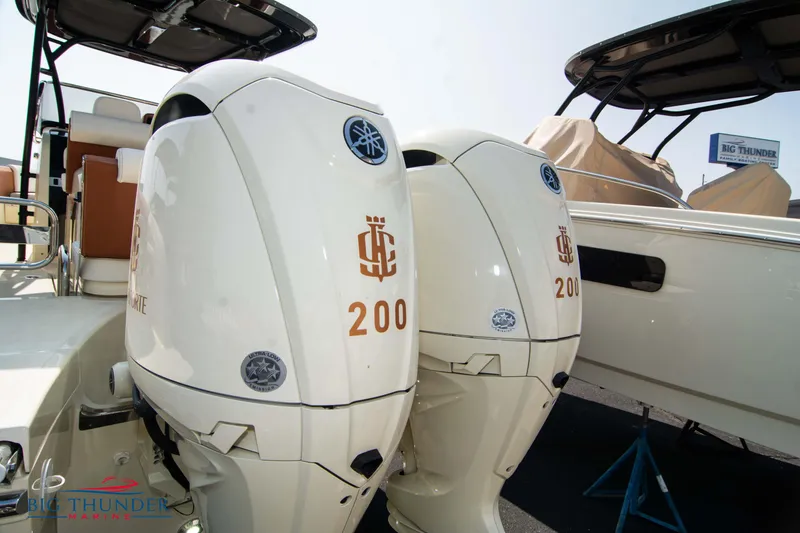 Slide: The Image of 2024 Capoforte FX270 boat with dual 200 horsepower engines, displayed at a marina. - 4