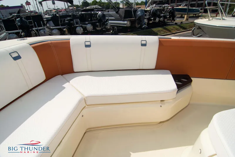 Slide: The Image of 2024 Capoforte FX270 boat interior with white and brown seating at Big Thunder Marine. - 42