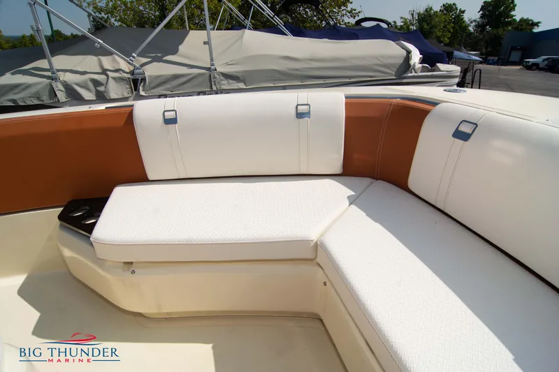 Slide: The Image of 2024 Capoforte FX270 boat interior with white and brown seating, showcased by Big Thunder Marine. - 43