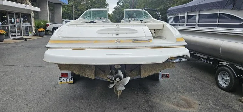 Slide: The Image of 2007 Maxum 2200 SR3 boat, rear view, parked on a trailer in a marina. - 11
