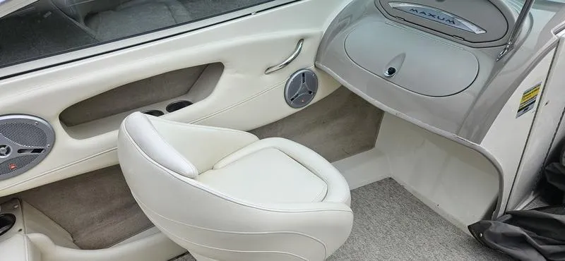 Slide: The Image of 2007 Maxum 2200 SR3 boat interior with white seating and speaker system. - 6