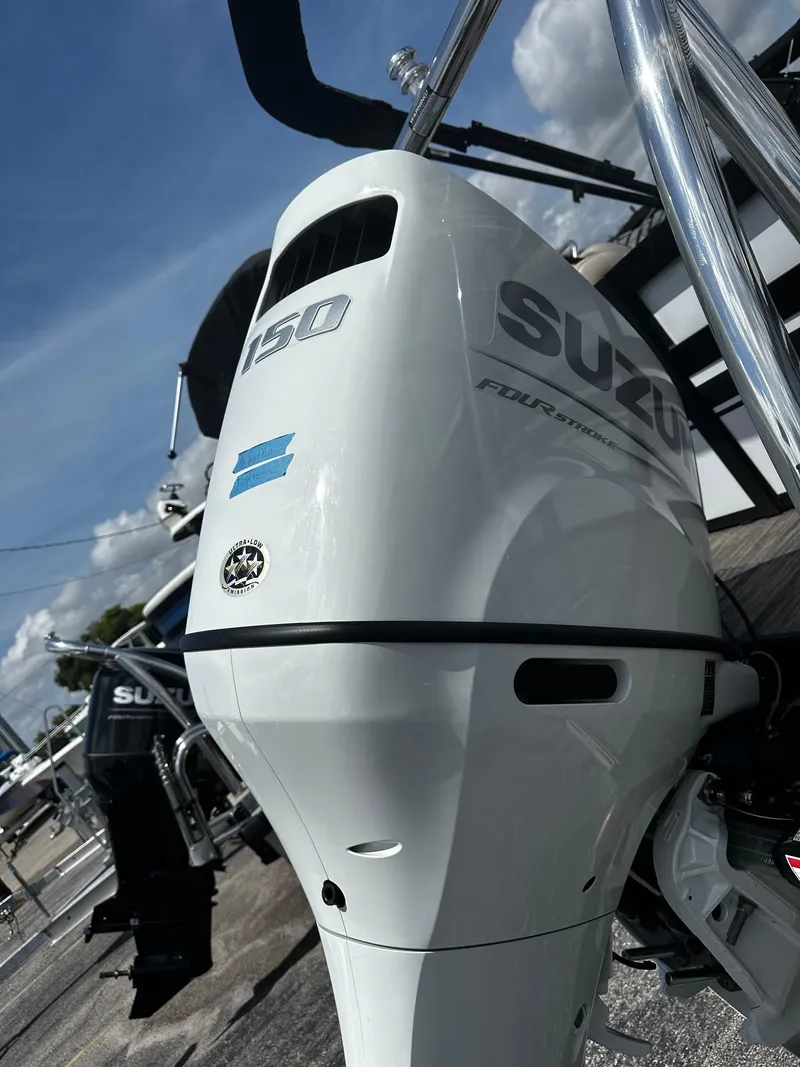 Slide: The Image of Viaggio Diamante 21U 2023 boat with Suzuki 150 outboard motor, docked under a clear sky. - 13