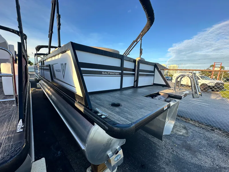 Slide: The Image of 2023 Viaggio Diamante 21U pontoon boat, saltwater edition, docked under clear blue sky. - 5