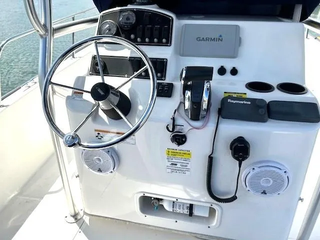 Slide: The Image of Boston Whaler 210 Montauk 2017 boat console with steering wheel and navigation equipment. - 13
