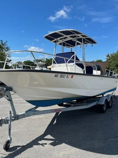 Slide: The Image of 2017 Boston Whaler 210 Montauk boat on trailer under clear blue sky. - 7