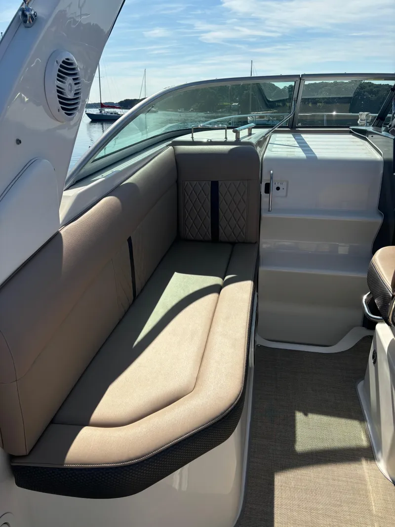 Slide: The Image of 2017 Sea Ray Sundancer 260 interior seating with beige upholstery and modern design. - 14