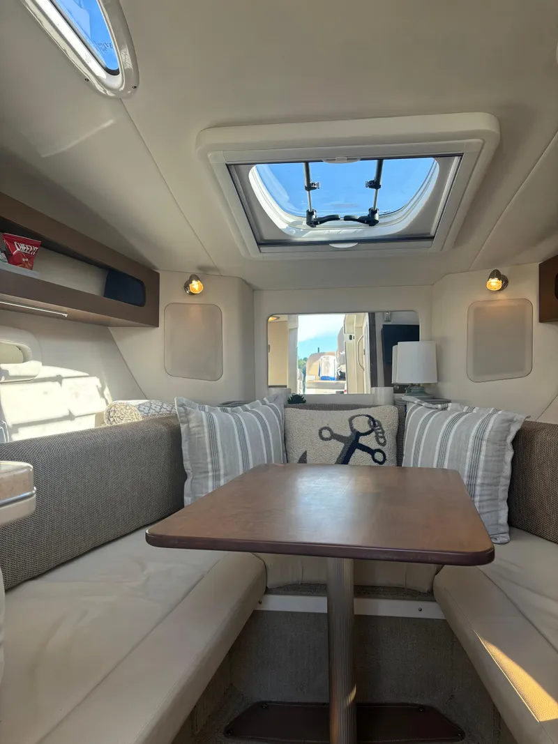 Slide: The Image of 2017 Sea Ray Sundancer 260 cabin interior with skylight and seating area. - 19