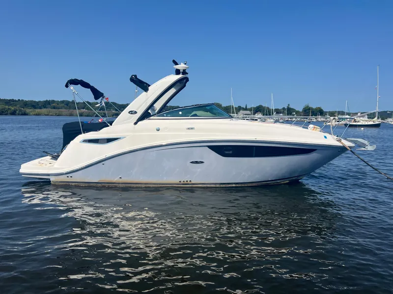 Slide: The Image of 2017 Sea Ray Sundancer 260 boat on calm water, clear sky background. - 20