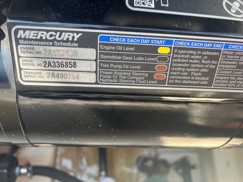 Slide: The Image of Mercury maintenance schedule label on a 2017 Sea Ray Sundancer 260 boat engine. - 23