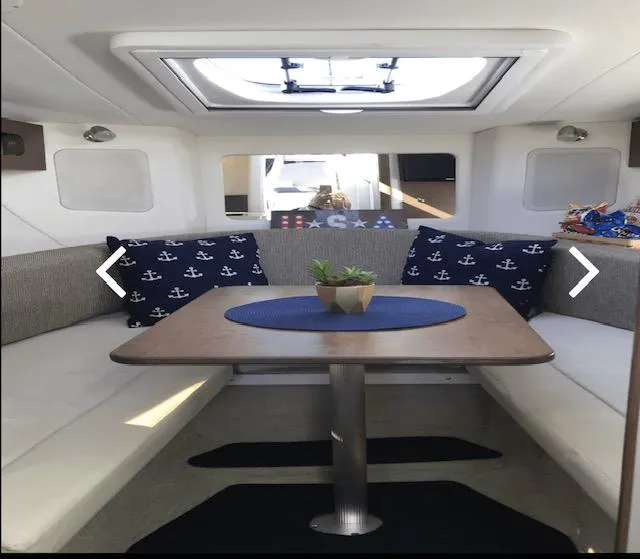 Slide: The Image of Interior of 2017 Sea Ray Sundancer 260 with cozy seating and nautical decor. - 4