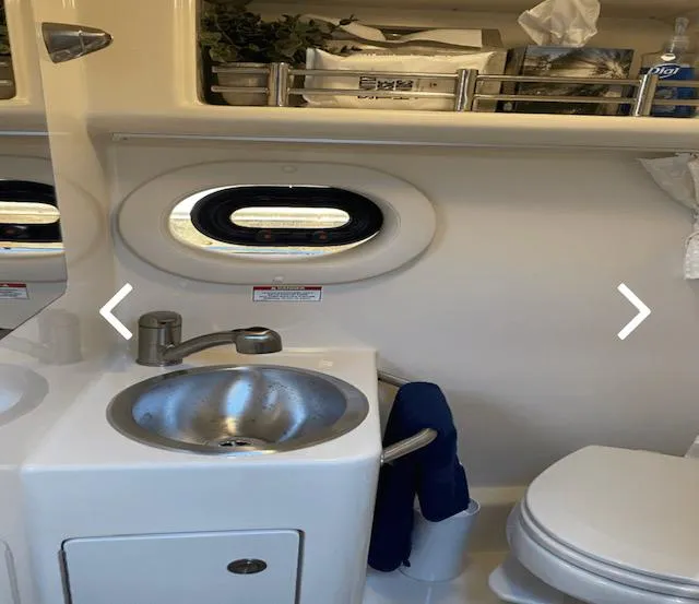 Slide: The Image of 2017 Sea Ray Sundancer 260 bathroom with sink, toilet, and storage shelf. - 5