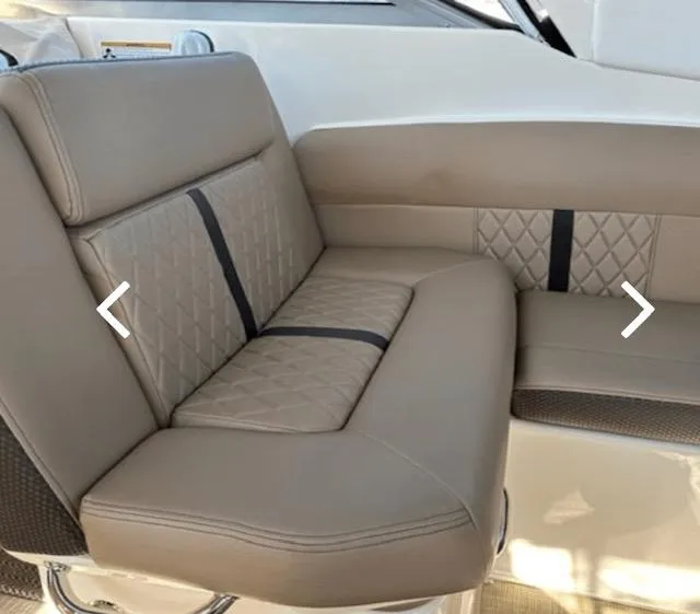 Slide: The Image of 2017 Sea Ray Sundancer 260 interior seating with beige upholstery and quilted design. - 7