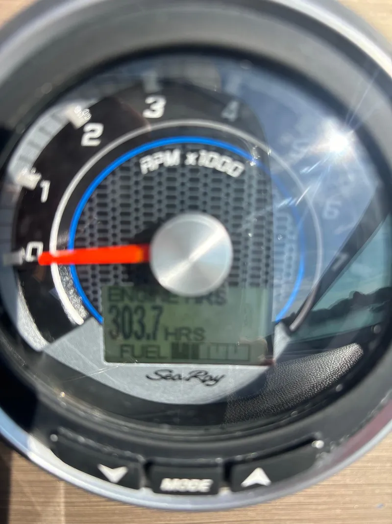Slide: The Image of Close-up of 2017 Sea Ray Sundancer 260 tachometer displaying 303.7 hours. - 8
