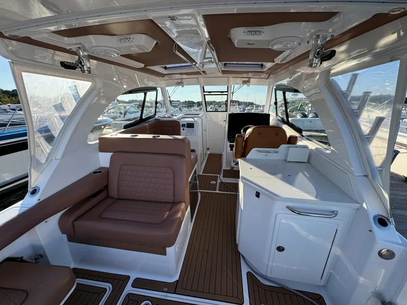 Slide: The Image of Luxurious interior of a 2020 Southport 33 DC boat with brown seating and white cabinetry. - 10