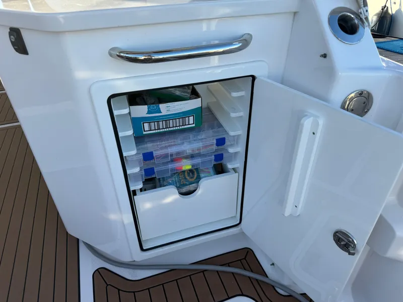 Slide: The Image of Storage compartment on 2020 Southport 33 DC boat with organized tackle boxes. - 15