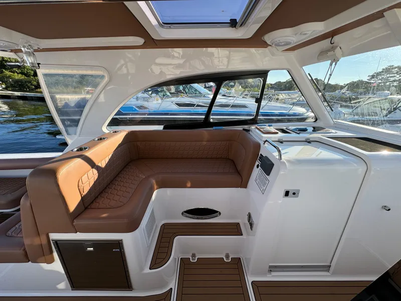 Slide: The Image of Luxurious interior of 2020 Southport 33 DC boat with brown leather seating. - 18