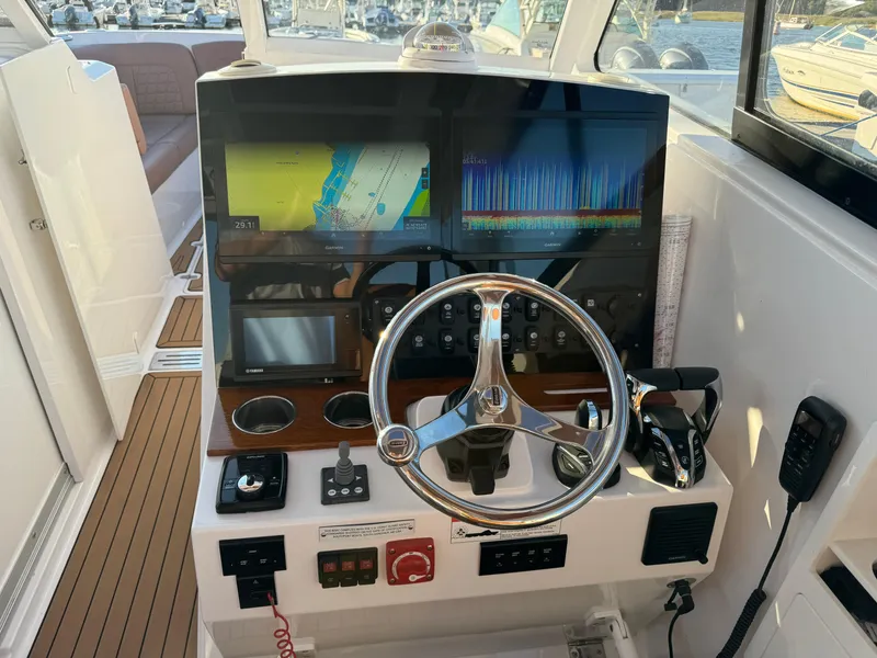 Slide: The Image of 2020 Southport 33 DC helm with dual displays and modern controls. - 20