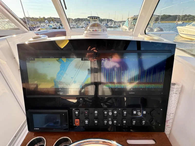 Slide: The Image of Helm of 2020 Southport 33 DC boat with navigation screens and controls. - 21