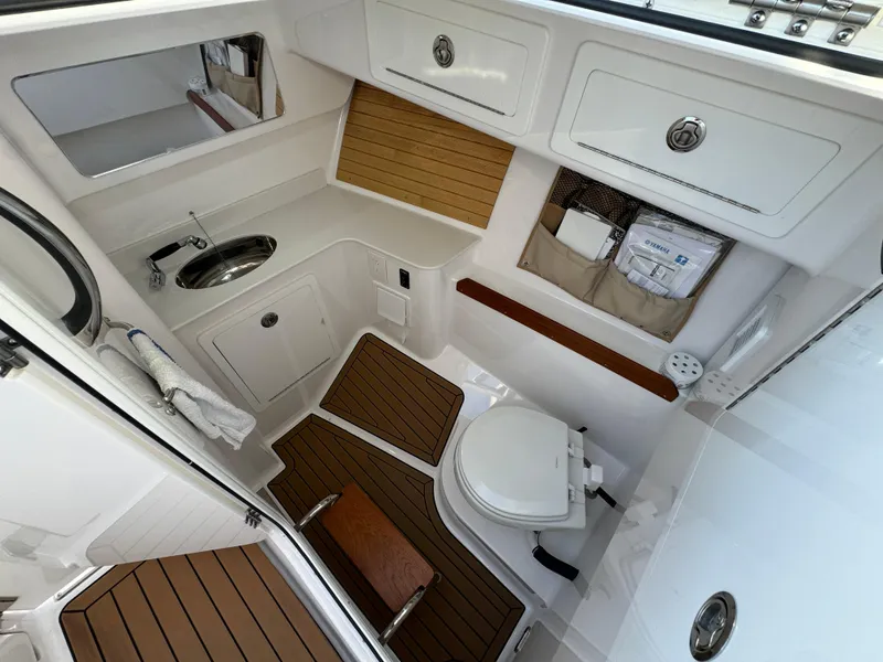 Slide: The Image of 2020 Southport 33 DC boat interior with sink, toilet, and storage compartments. - 25