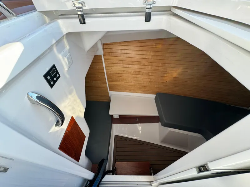 Slide: The Image of 2020 Southport 33 DC cabin interior with wood paneling and seating area. - 26