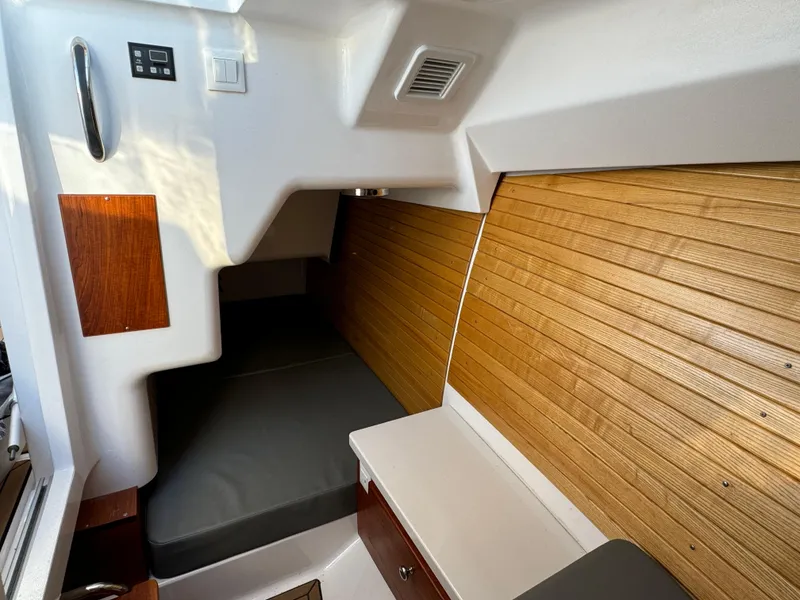 Slide: The Image of 2020 Southport 33 DC cabin interior with wood paneling and cushioned seating. - 27