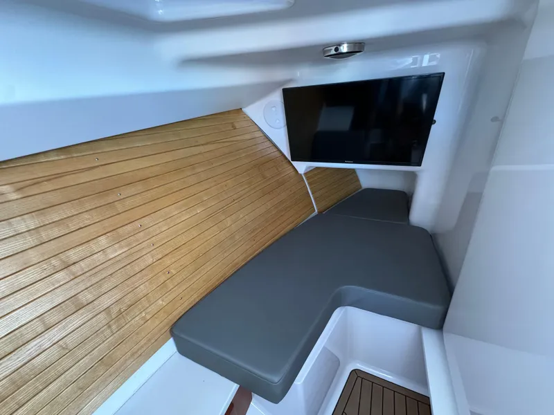 Slide: The Image of 2020 Southport 33 DC cabin interior with wood flooring and gray seating. - 28