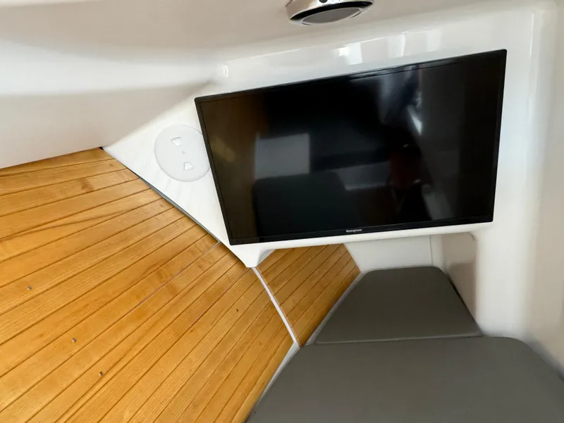 Slide: The Image of 2020 Southport 33 DC cabin interior with TV and wooden flooring. - 29