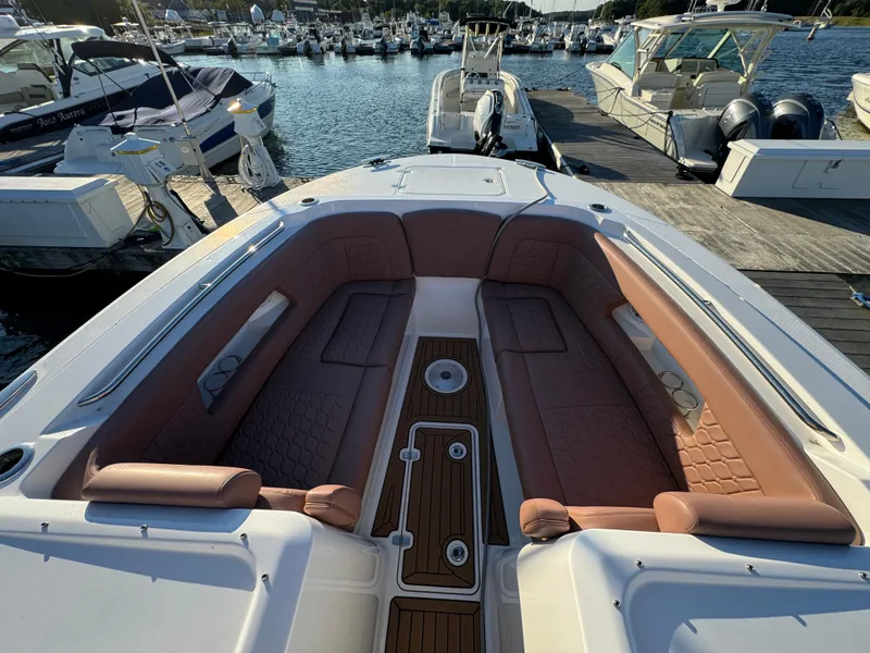 Slide: The Image of 2020 Southport 33 DC boat with spacious seating at a marina dock. - 30