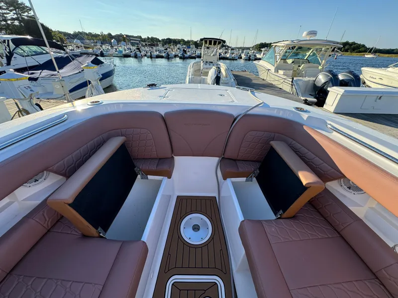 Slide: The Image of 2020 Southport 33 DC boat interior with luxurious seating at a marina. - 31